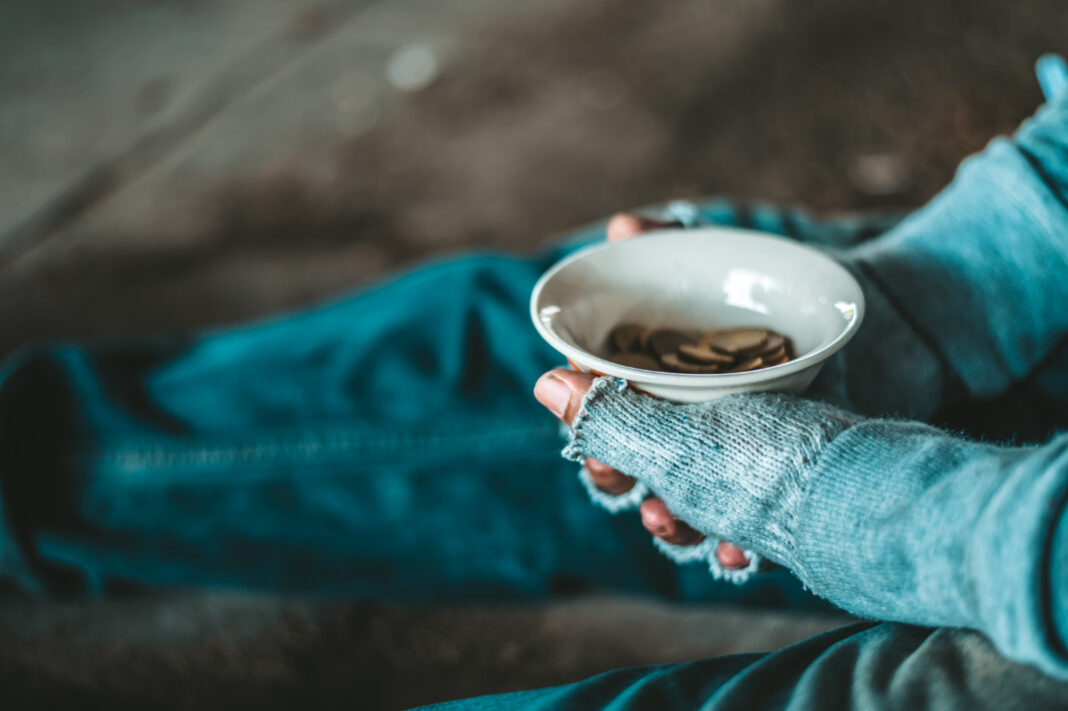 beggars-sitting-under-a-bridge-with-cups-have-money0
