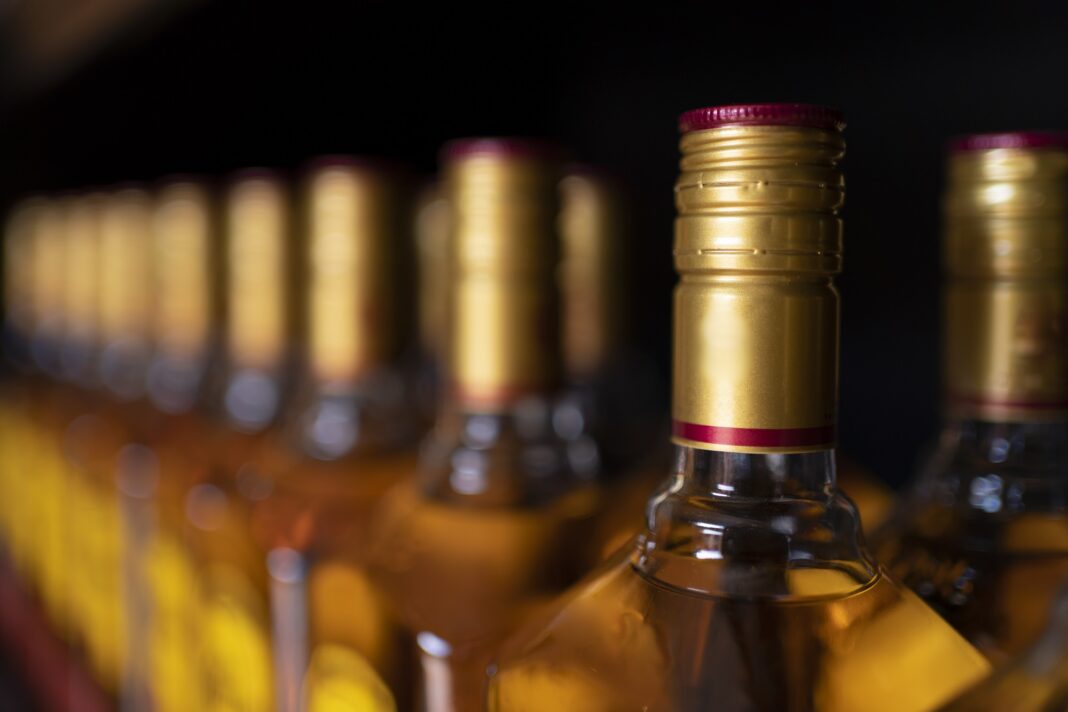 Closeup shot of the bottles of tequila on a black background0