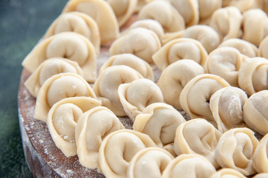 front-close-view-tasty-little-dumplings-on-dark-blue-dough-color-meat-food-calorie-meal-food-dish0