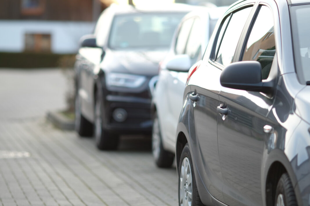 closeup-shot-black-car-parking-lot-with-blurred-background0