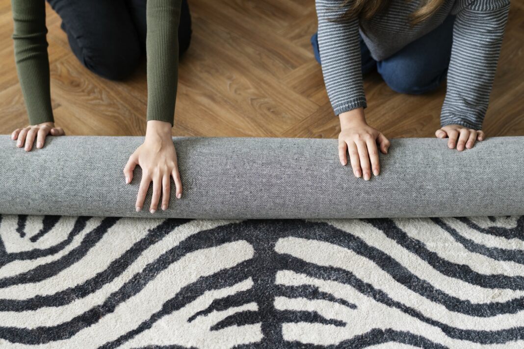 Friends rolling a carpet0