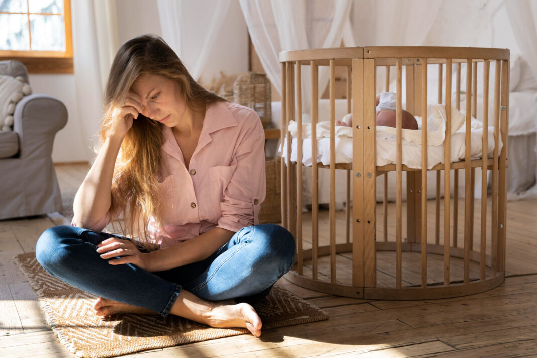 close-up-tired-mom-taking-care-newborn-baby0