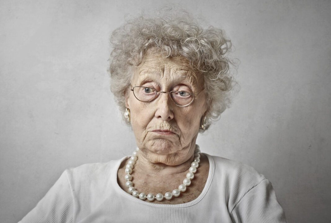 elderly-woman-against-white-wall-with-blank-stare0